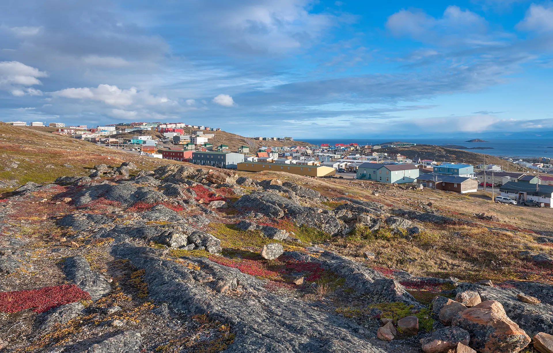 Overview of the city of Iqaluit with the Arctic Ocean harbor in the distance
