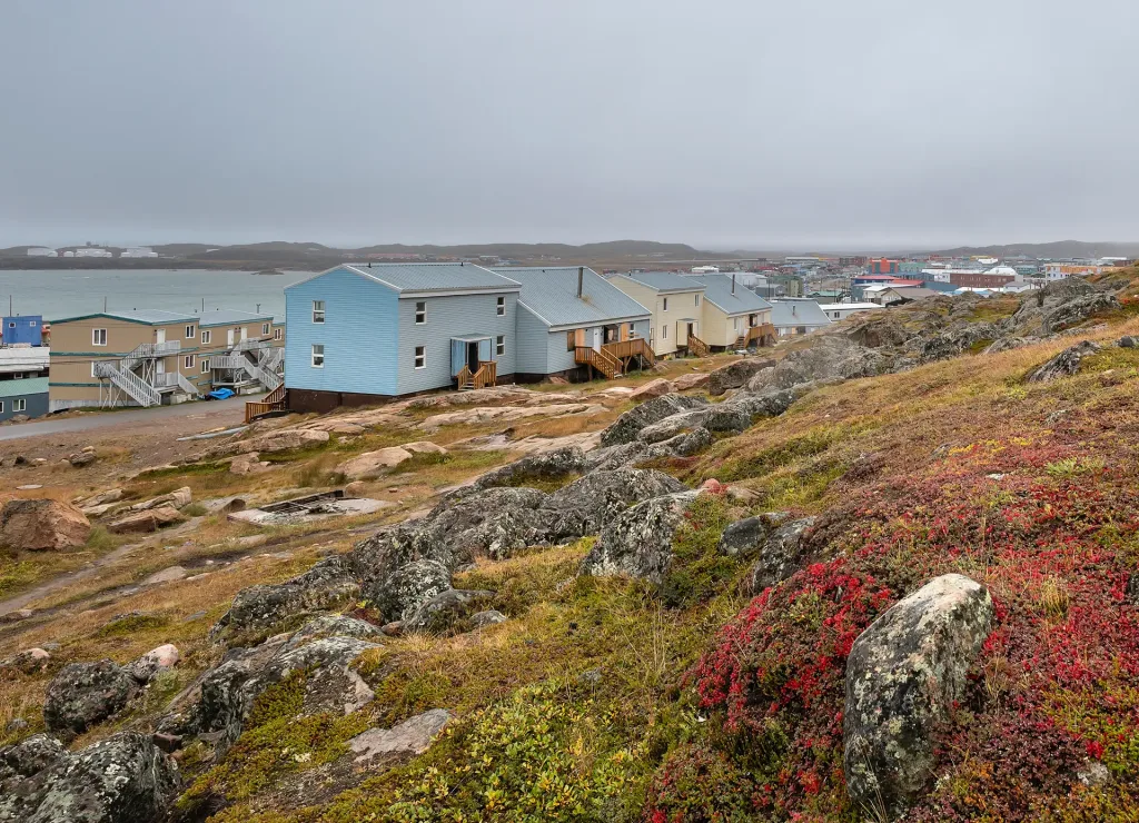 Houses on a rocky hillside beside the Arctic Ocean at Iqaluit