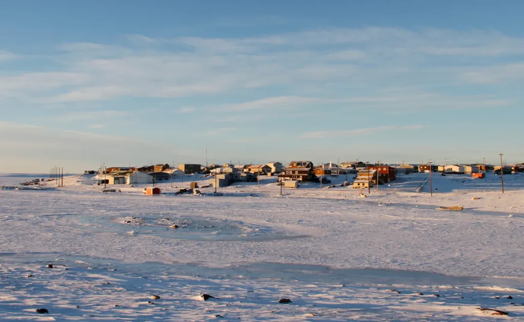 Arctic community of Cambridge Bay in the fall with snow on the ground and blue skies